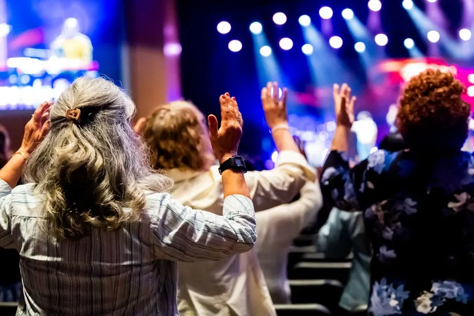 Worshippers with hands raised at Grace Community