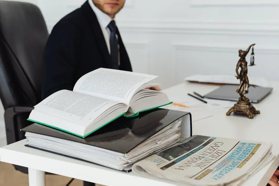 Halberd & Stone attorney at a desk surrounded by legal books, documents, and case files