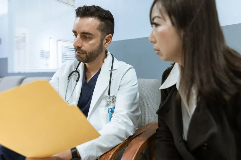 A Bridgepoint doctor discussing health records with a patient in our consulting room