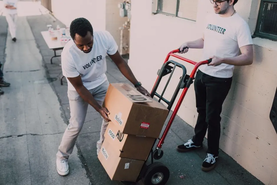 Volunteers carrying boxes of aid