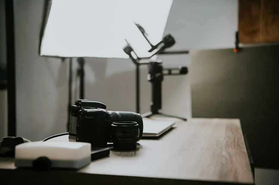 DSLR camera and lens on a wooden table in studio light