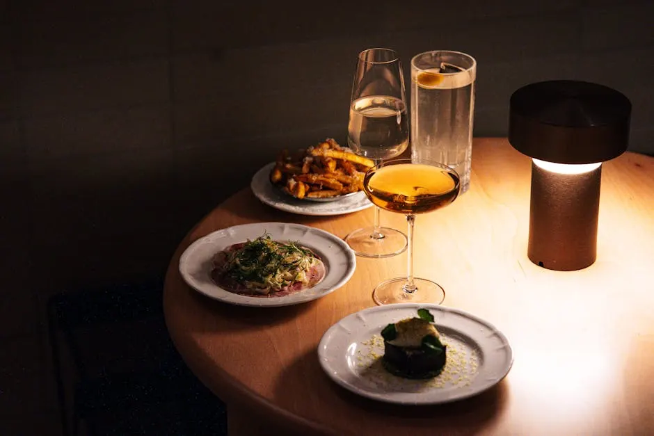 A sophisticated multi-course dinner setting with wine glasses and elegant plating